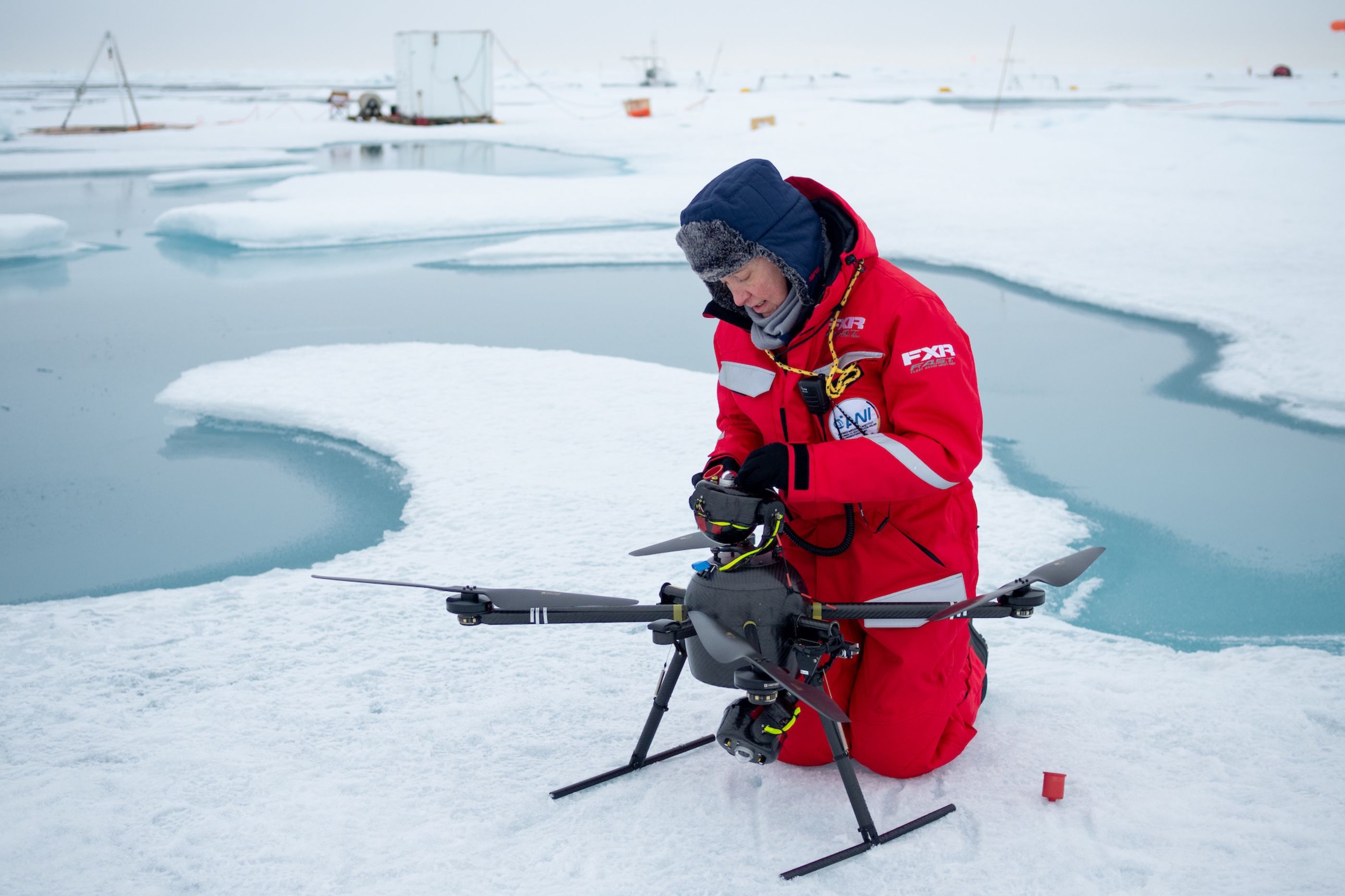 Roberta Pirazzini (MOSAiC Team Ice) prepares a drone to conduct energy budget measurements.